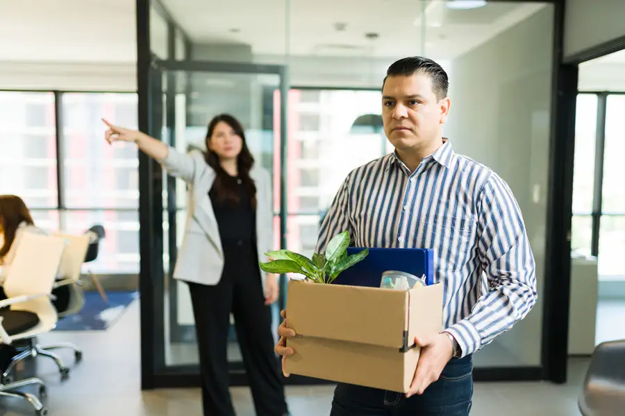 A male employee being fired by an angry manager