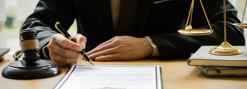 Lawyer at a desk reviewing a settlement document