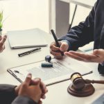 Business people and lawyers talk and contract together. Signing of a contract in the presence of an attorney.