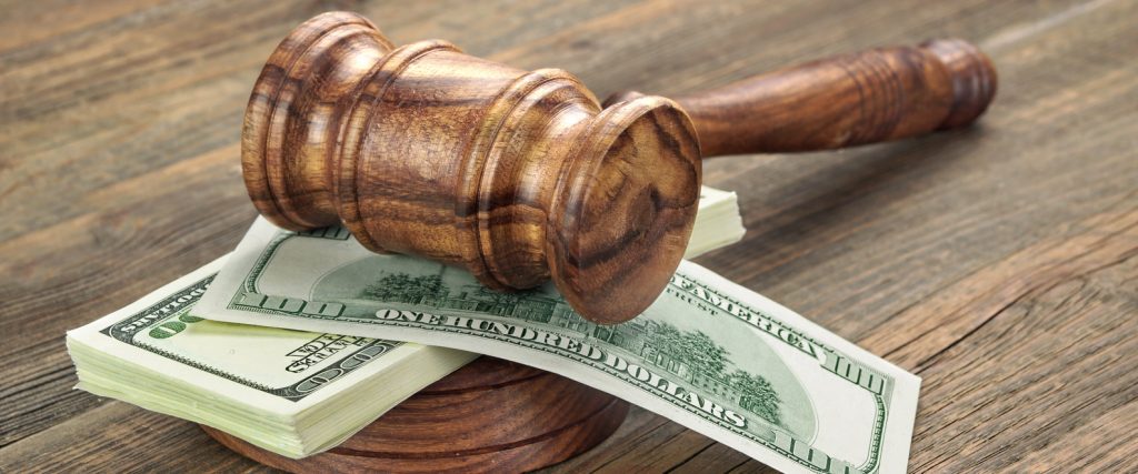 Stack Of Dollar Banknotes With Judges Or Auctioneers Gavel Or Hammer, Trial Or Tribunal Concept, Auction Concept, Close Up