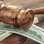 Stack Of Dollar Banknotes With Judges Or Auctioneers Gavel Or Hammer, Trial Or Tribunal Concept, Auction Concept, Close Up