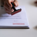 Lending concept. Pre-approved mortgage loan. Business Man Stamping With Approved Stamp On Document. Business approve Stamp and certificate concept. Businessman Hands Stamping a document